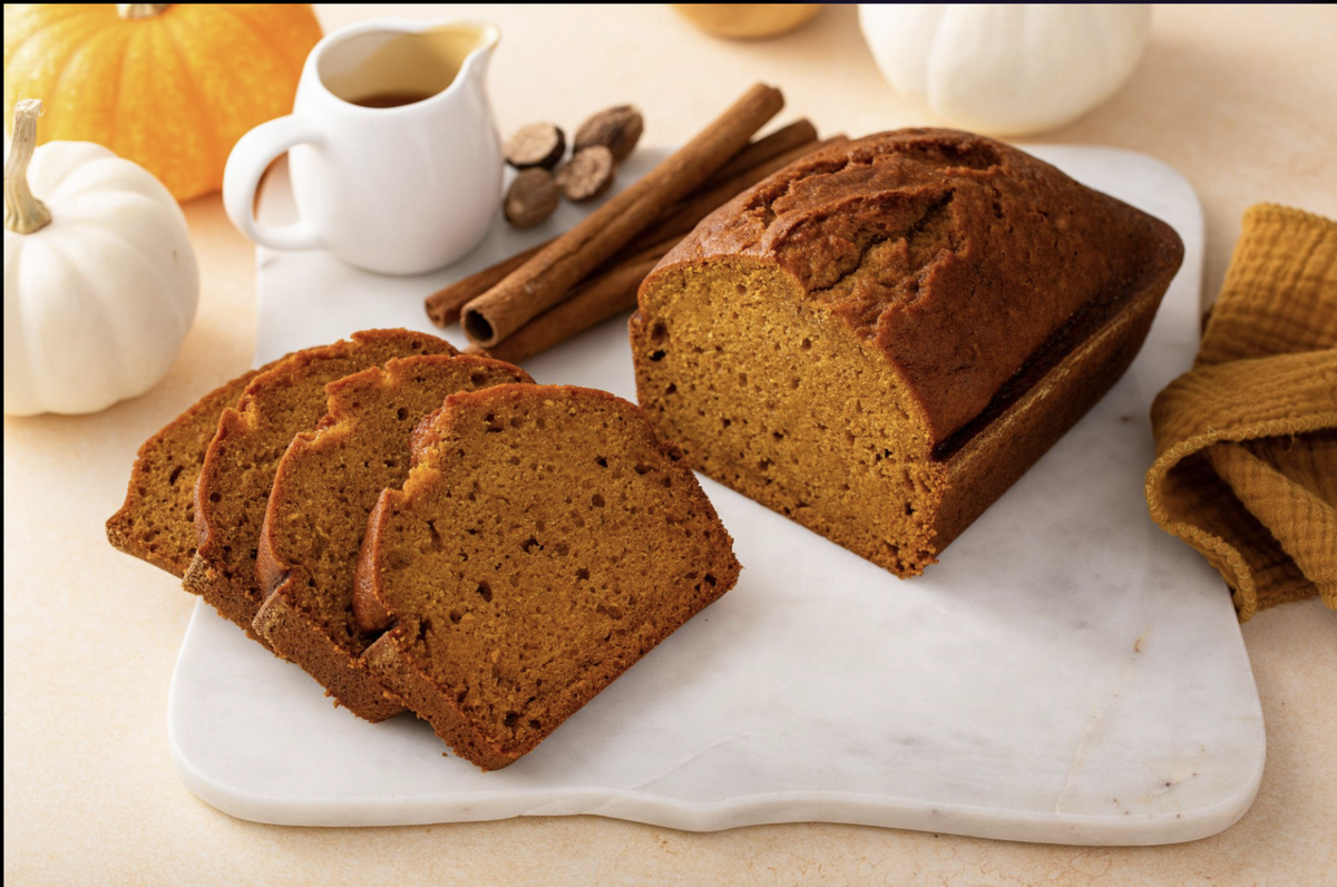 Sliced pumpkin loaf with cinnamon and pumpkins